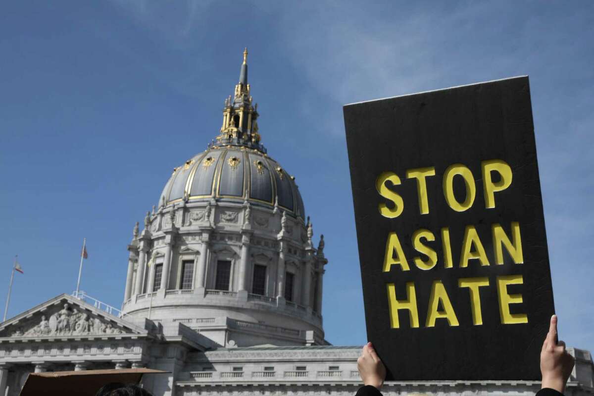 A demonstrator holds a sign saying Stop Asian Hate as they march toward City Hall after rallying in front of the Hall of Justice  on March 22, 2021 in San Francisco.