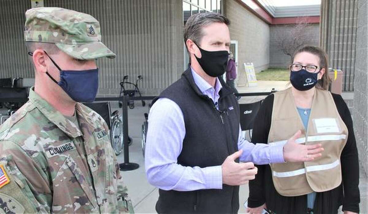 U.S. Rep. Rodney Davis, R-Taylorville, is flanked by Staff Sgt. . Collin Cummings, the non-commissioned officer in charge for the Illinois National Guard Madison County’s operations, and Amy Yeager, director of community health and public information officer for the Madison County Health Department, while speaking to the media after touring the Health Department’s vaccination site at Gateway Convention Center in Collinsville Monday morning.