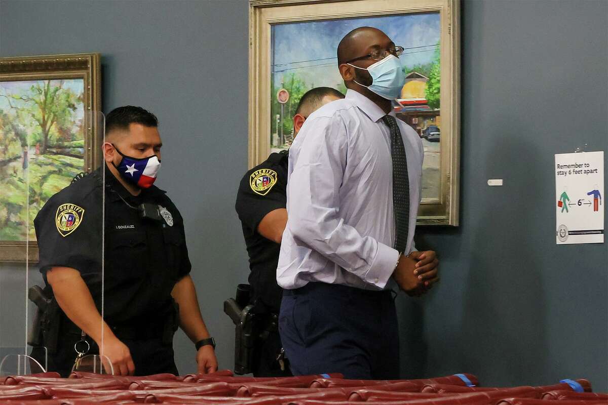 Otis McKane is led out by Bexar County sheriff’s deputies during a break in individual jury selection for his capital murder trial Monday, March 22, 2021, in the Central Jury Room at the Cadena-Reeves Justice Center. McKane is accused of killing San Antonio Police Detective Benjamin Marconi.