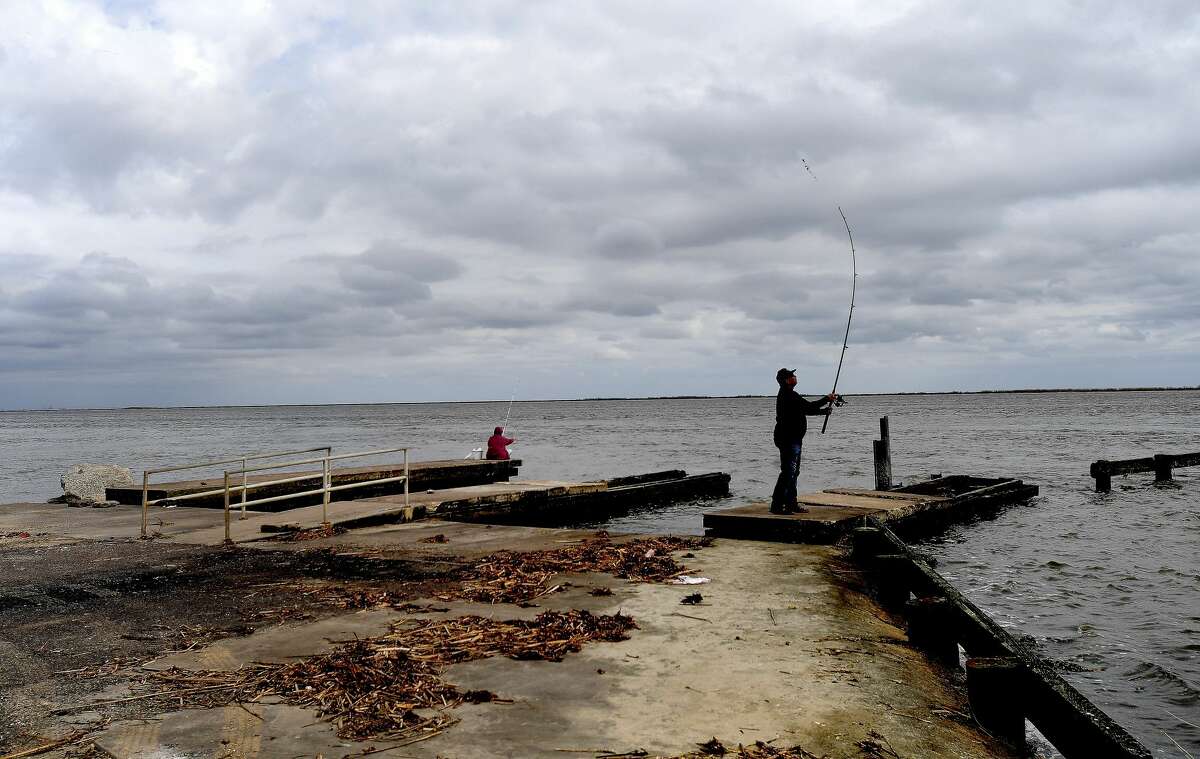 Gilbert Delgado and Jodie Bowen of Orange spend time fishing at Mesquite Point Monday near a boat ramp that was damaged during Tropical Storm Harvey. Jefferson County is moving forward with plans to repair the ramp using a grant from Texas Parks and Wildlife. Photo made Monday, March 22, 2021 Kim Brent/The Enterprise