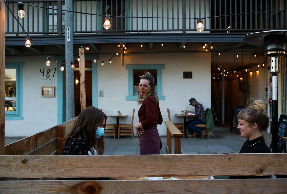 Lauren Feldman converses with dinner guests in the sidewalk parklet at Valley Bar & Bottle, a new wine shop, bar and restaurant in Sonoma.