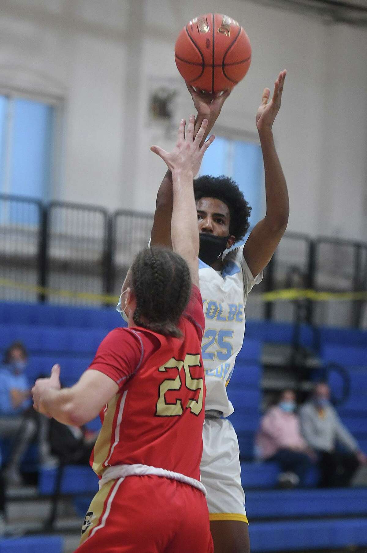 Kolbe Cathedral's Tyrell Staples-Santos shoots a jumper over Stratford defender Jayden Perez during the first half of the SWC tournament semifinals at the Cardinal Sheehan Center in Bridgeport, Conn. on Monday, March 22, 2021.