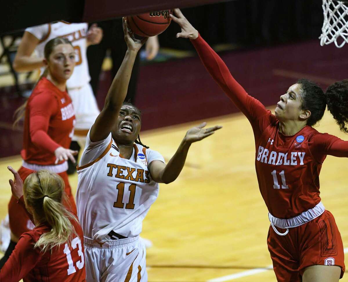 Joanne Allen-Taylor (11) of Texas shoots a layup as Lasha Petree (11) and Tatum Koenig (13) of Bradley defend during the first round of the NCAA Division I Women's Basketball Tournament in San Marcos on Monday, March 22, 2021.