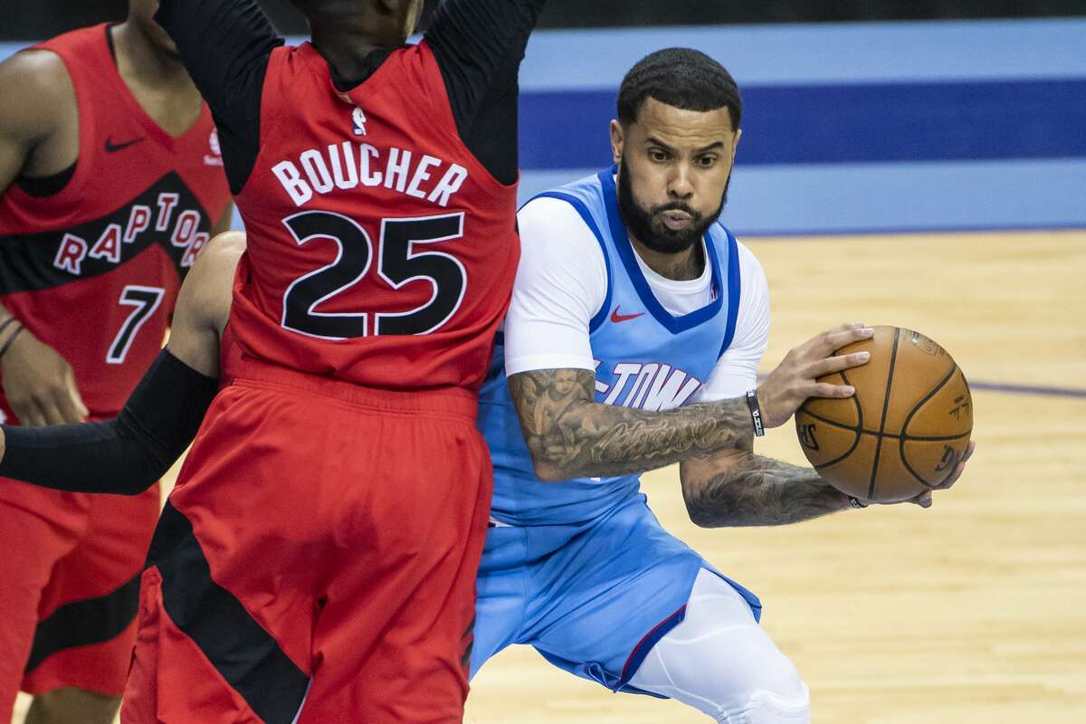 Houston Rockets guard D.J. Augustin (14) looks to pass around Toronto Raptors forward Chris Boucher (25) during the fourth quarter of an NBA game between the Houston Rockets and Toronto Raptors on Monday, March 22, 2021, at Toyota Center in Houston.