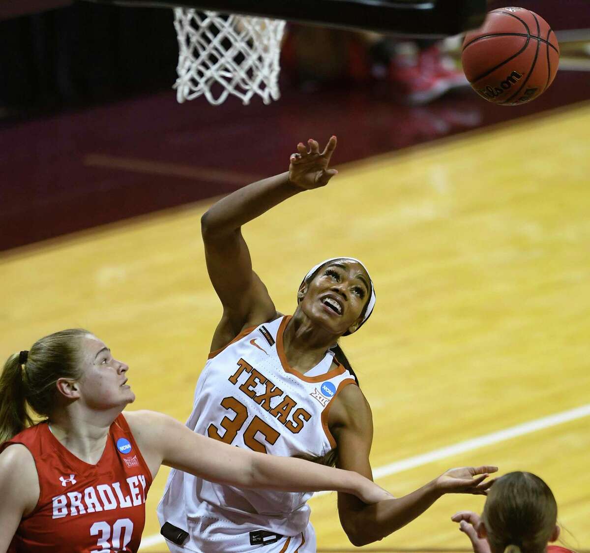 Texas center Charli Collier (35) battles Emily March (30) and Gabi Haack (3) of Bradley for a rebound during the first round of the NCAA Division I Women’s Basketball Tournament in San Marcos on Monday, March 22, 2021.