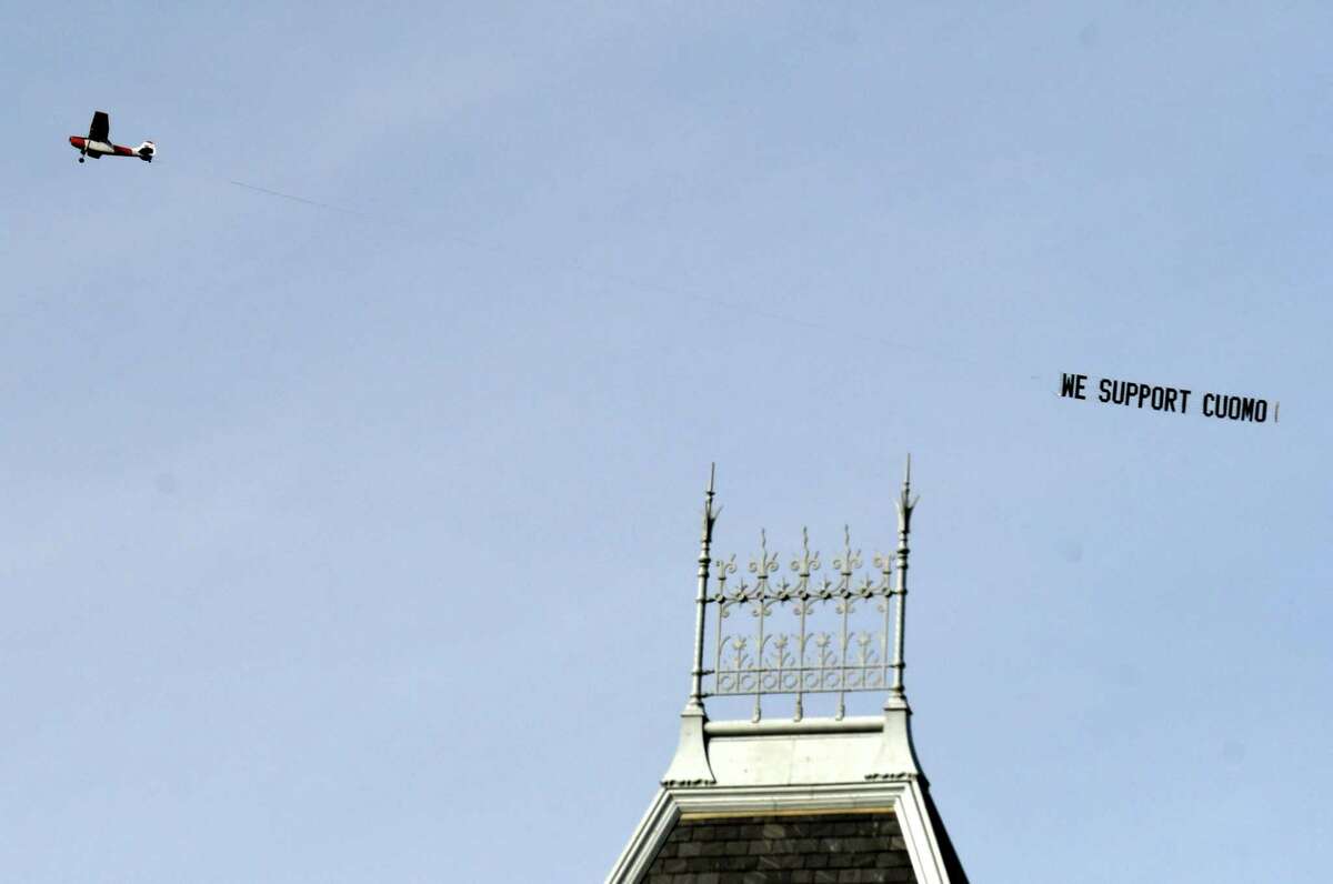 A airplane flies over Albany carrying a banner supporting Gove. Andrew Cuomo on Tuesday, March 23, 2021, in Albany, N.Y. (Will Waldron/Times Union)