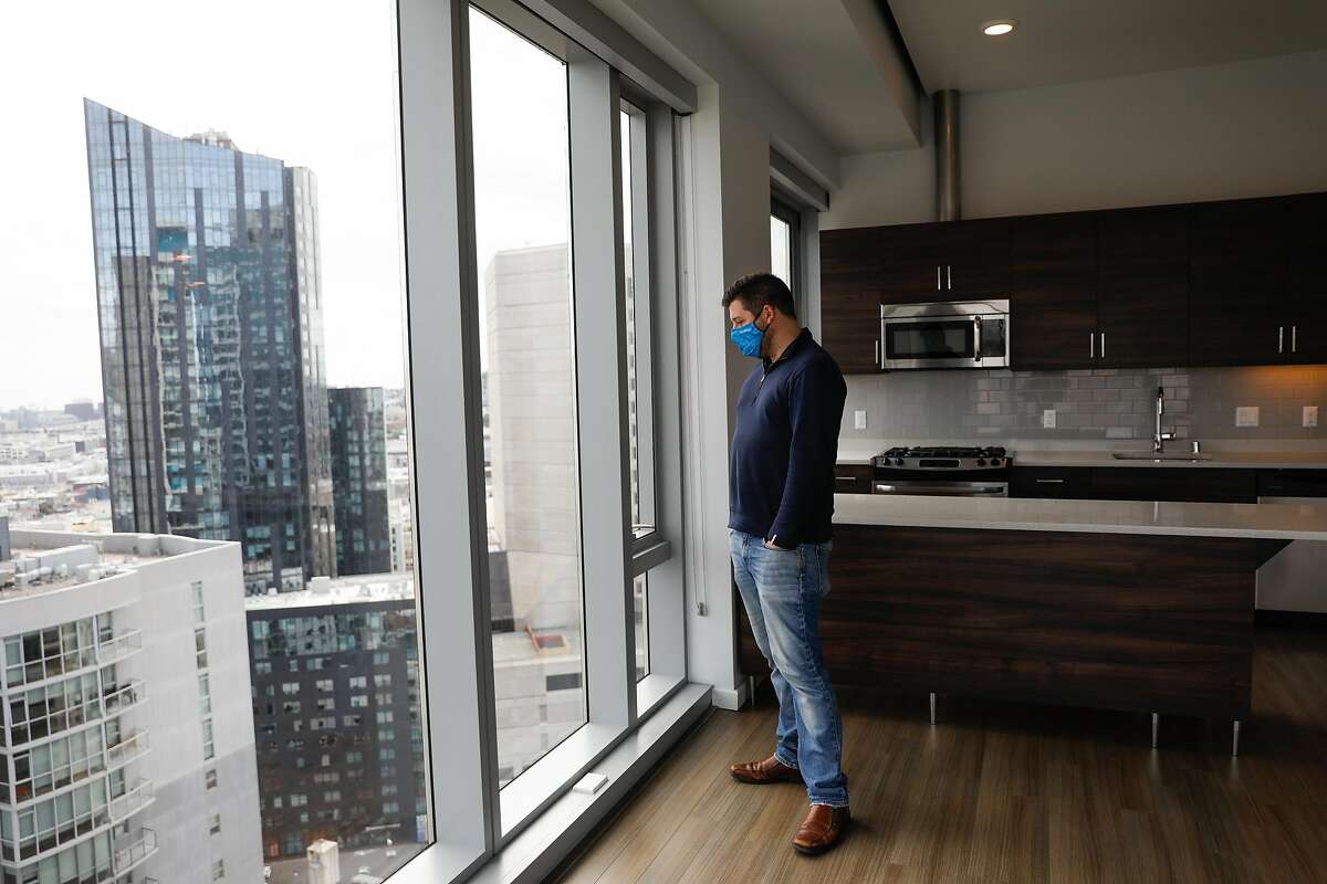 Manager Justin Sielbach gives a tour of a unit at the 100 Van Ness apartment building in San Francisco.