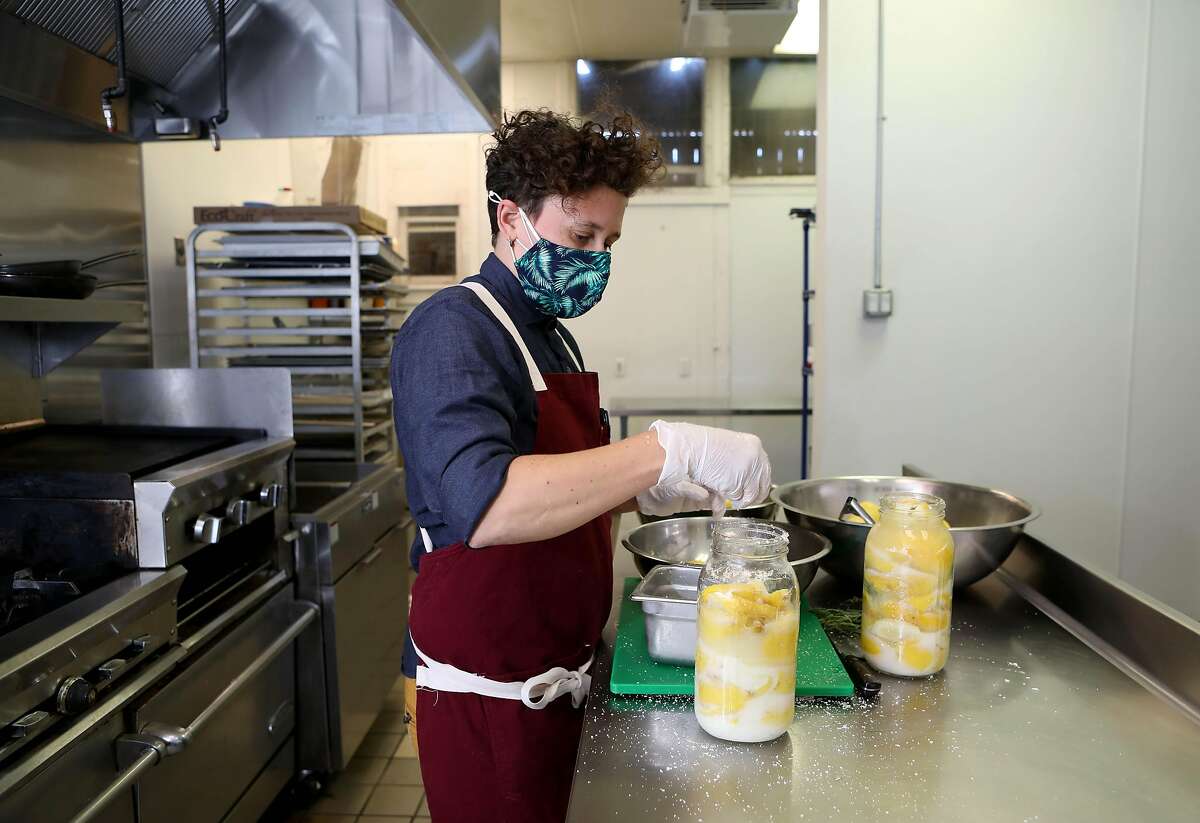 Lily Fahsi-Haskell, worker-leader, preserves lemons in the kitchen at Understory on Friday, March 19, 2021, in Oakland, Calif. Understory, a worker-led restaurant, bar, and commissary kitchen is serving a hybrid of Moroccan, Filipino and Mexican dishes. The project partners with Oakland Bloom, a non-profit that provides support to refugee, immigrant and women chefs of color.