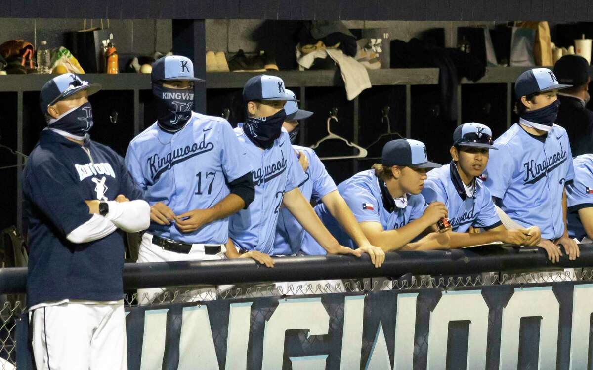 Kingwood head coach Kelly Mead and his players watch a play during the sixth inning of a District 21-6A baseball game against Atascocita at Kingwood High School, Tuesday, March 24, 2021, in Kingwood.