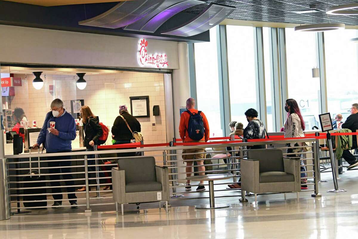 Passengers wait in line at Chick-fil-A at the Albany International Airport on Wednesday, March 24, 2021 in Colonie, N.Y. . (Lori Van Buren/Times Union)