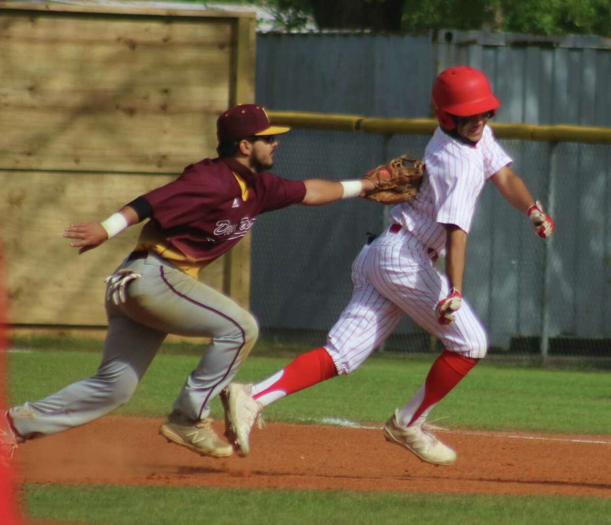 Deer Park second baseman Jesus Solano applies the tag on one of the few Trojans that found their way on the bases, the end result to a rundown.
