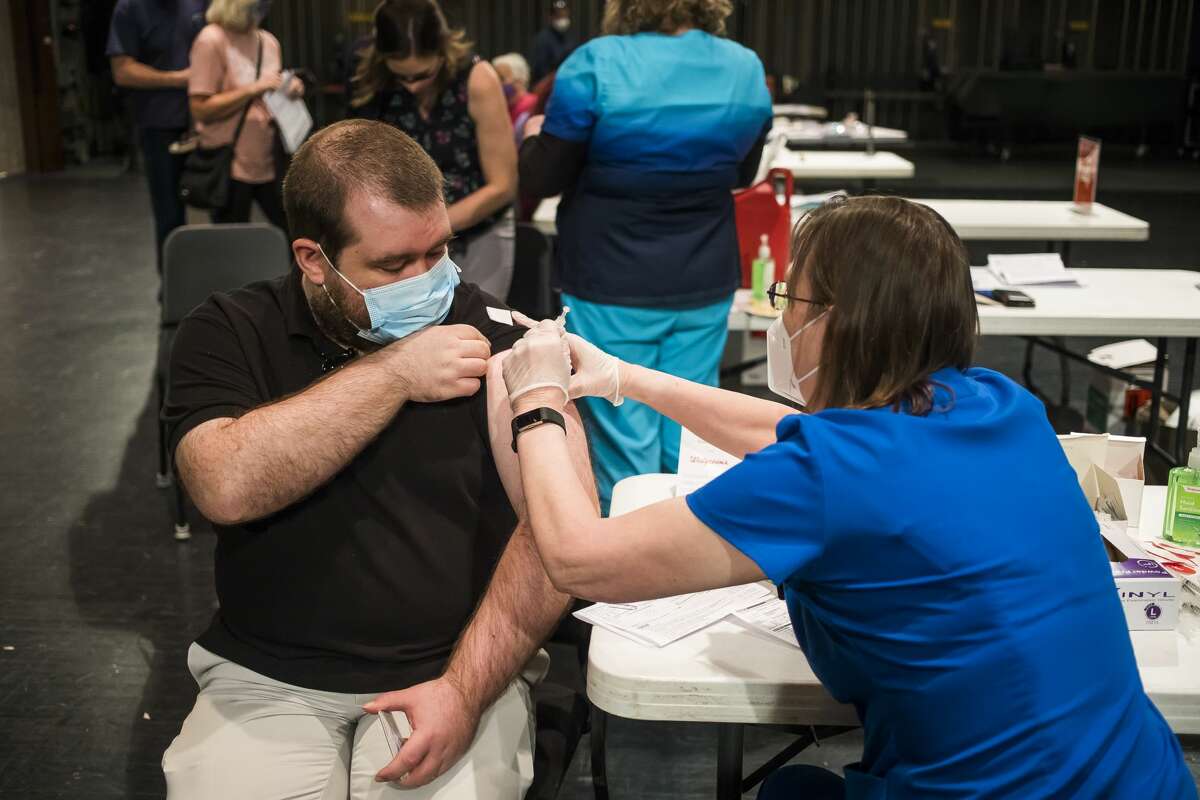 FILE — Hundreds of people receive the Pfizer COVID-19 vaccine during a clinic held in partnership with Walgreens on March 24, 2021 at the Midland Center for the Arts.