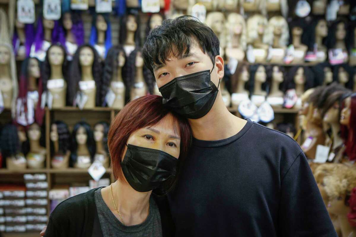 Sungjun Lee holds his mother Jung Kim, who own Uptown Beauty Supply, 12412 Kuykendahl Rd. They were victims as customers assaulted the family on March 17 at the store in an unprovoked attack Wednesday, March 24, 2021, in Houston.