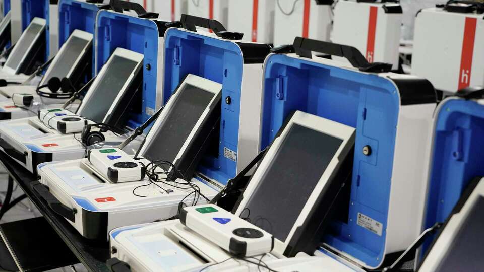 New voting machine are shown at the Harris County Election Technology Center, 11525 Todd St., Wednesday, March 24, 2021 in Houston. A ballot is printed and inserted into the separate machine, that counts the ballot and then deposits it in the ballot box.