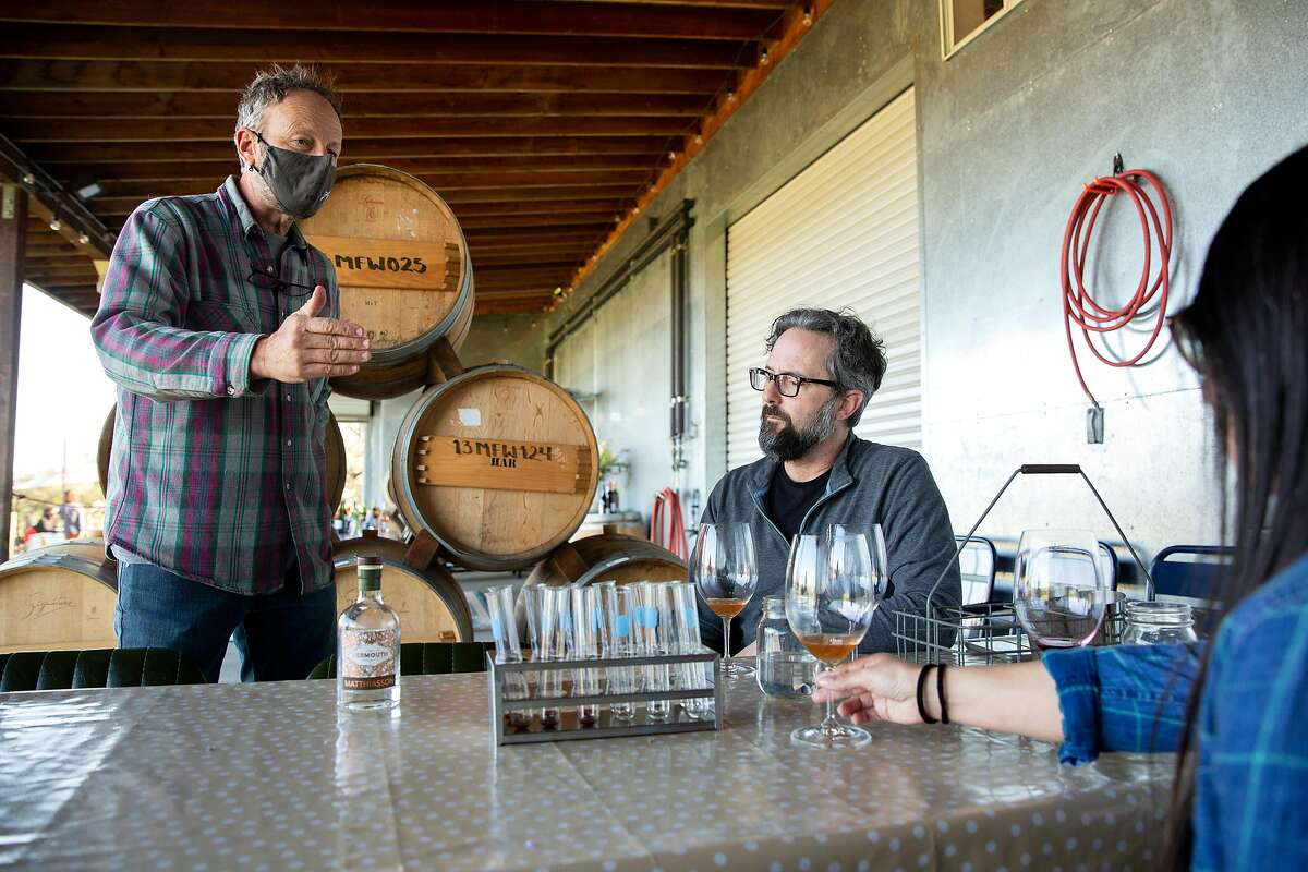 Owner Steve Matthiasson talks with guests Barry and Celia Cowan during their wine tasting at Matthiasson Winery in Napa on March 13, 2021. Napa County advanced into the state’s least-restrictive coronavirus economic reopening tier Tuesday.