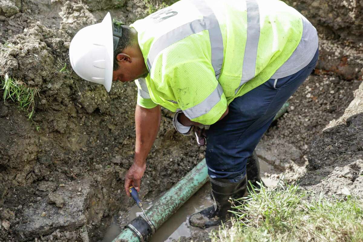 A worker repairs a sewer line in the 5400 block of Pardee Street in Houston, TX on Saturday, June 11, 2016. A federal judge on Wednesday approved a $2 billion consent decree the requires the city to upgrade its sewer pipes.