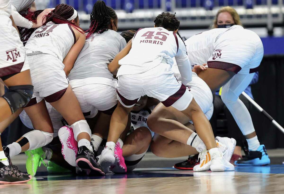 SAN ANTONIO, TEXAS - MARCH 24: Jordan Nixon #5 of the Texas A&M Aggies is surrounded by teammates after making the game winning basket to defeat the Iowa State Cyclones in overtime 84-82 in the second round game of the 2021 NCAA Women's Basketball Tournament at the Alamodome on March 24, 2021 in San Antonio, Texas.