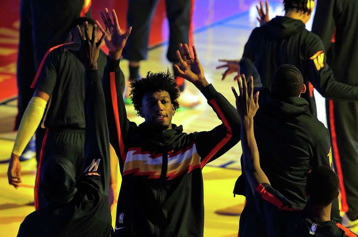 James Wiseman high fives teammates during pregame intros before the game between the Golden State Warriors and the Philadelphia 76ers at Chase Center in San Francisco, Calif., on Tuesday, March 23, 2021.
