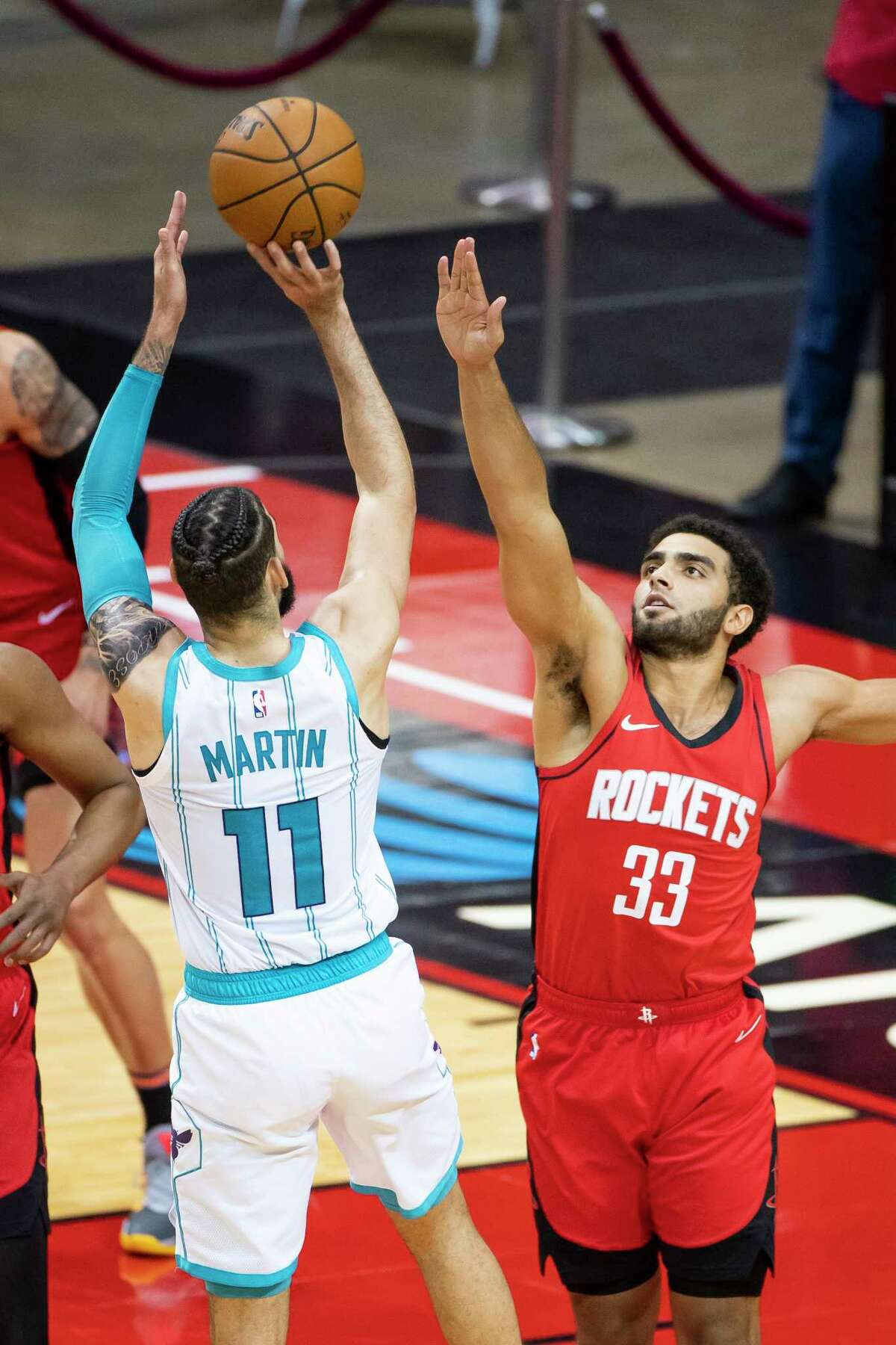 Houston Rockets forward Anthony Lamb (33) defends a shot by Charlotte Hornets forward Cody Martin (11) during the fourth quarter of an NBA game between the Houston Rockets and Charlotte Hornets on Wednesday, March 24, 2021, at Toyota Center in Houston.