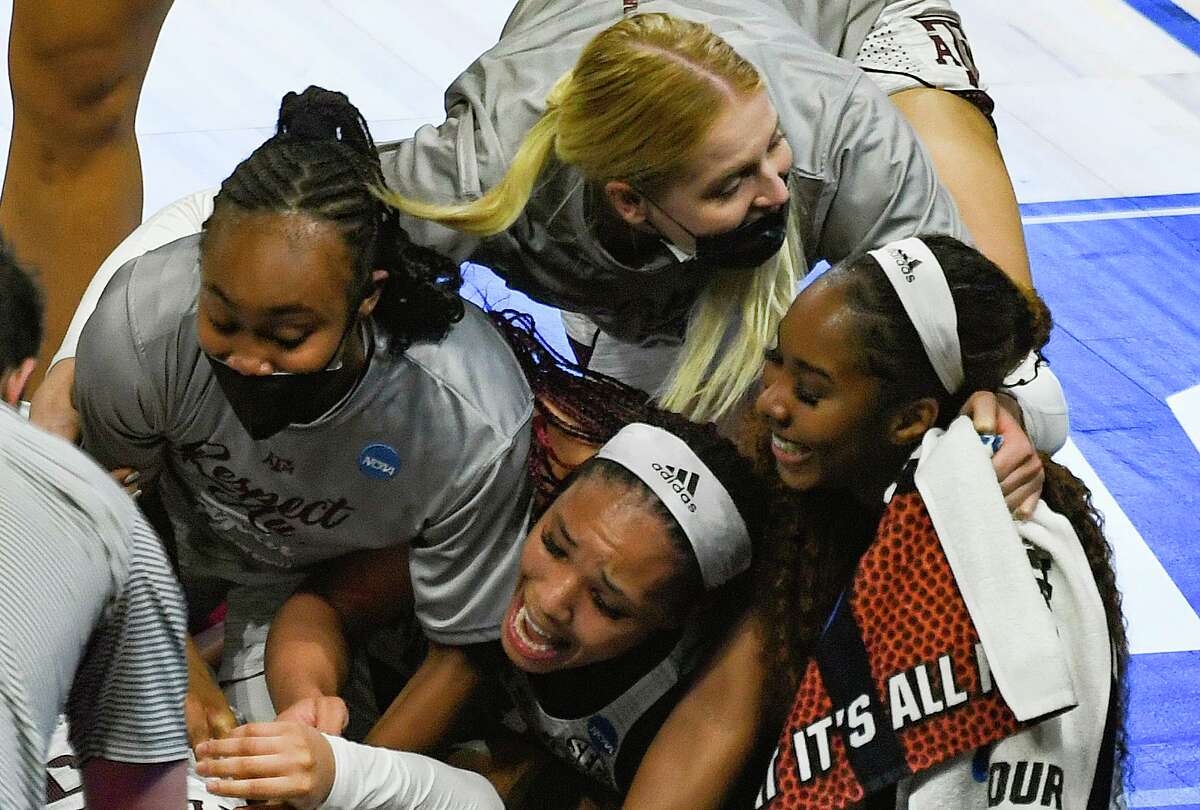 Texas A&M players celebrate their 84-82 overtime victory over Iowa State in the NCAA Women’s Basketball Championship tournament to advance to the Sweet 16 in in the Alamodome on Wednesday, March 24, 2021.