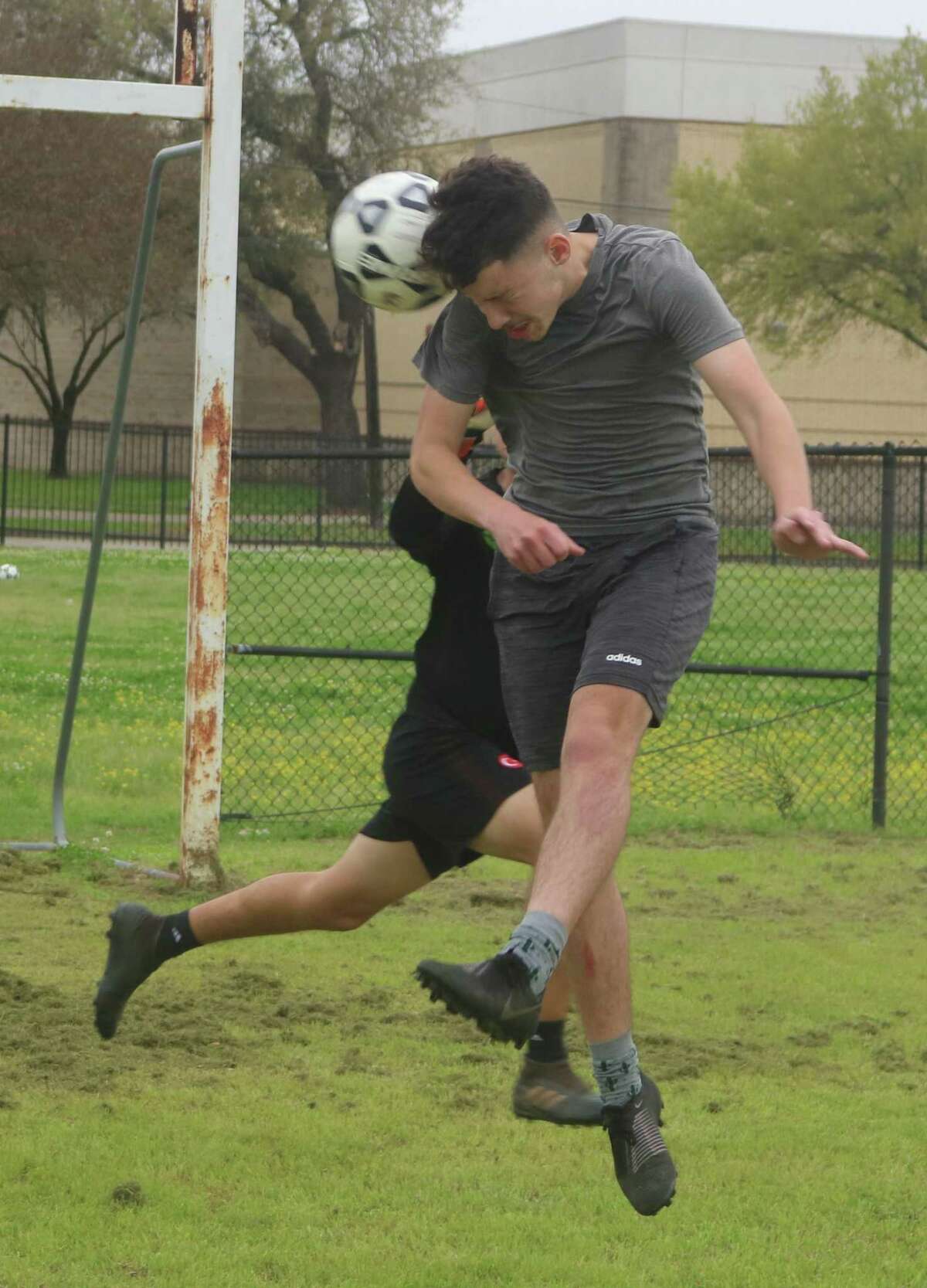 Anthony Almague attempts a header into the goal during Wednesday's practice as the Eagles prepared for their bi-district match with Humble Friday night.