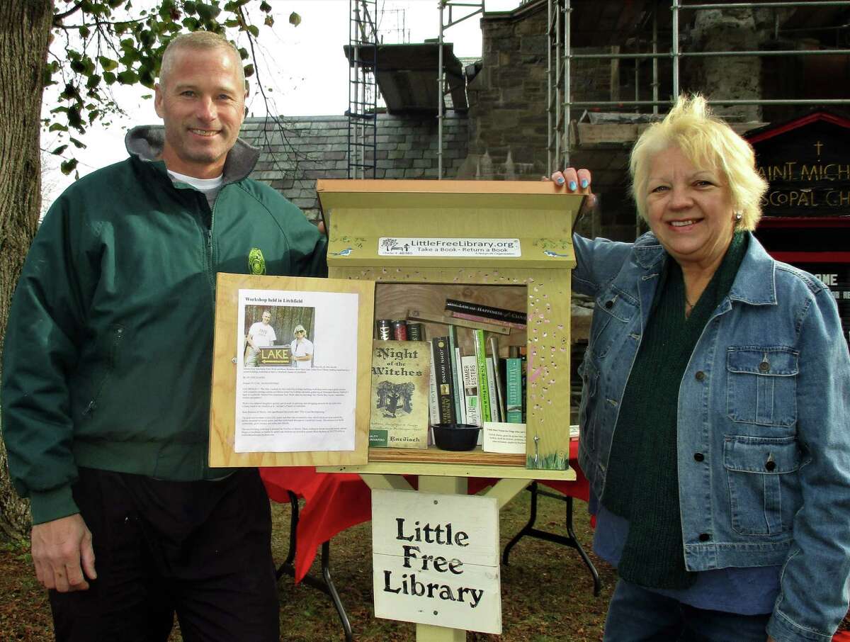 Morris First Selectman Tom Weik and columnist Jo Ann Jaacks by the church's Little Free Library.