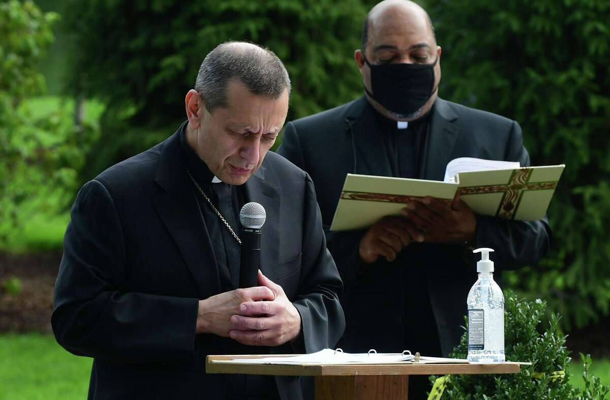 Bishop Frank Caggiano and Rev. Reginald D. Norman lead a ceremony at Our Lady of Fatima Catholic Church in Wilton last August.
