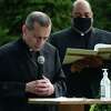 Bishop Frank Caggiano and Rev. Reginald D. Norman lead a ceremony at Our Lady of Fatima Catholic Church in Wilton last August.