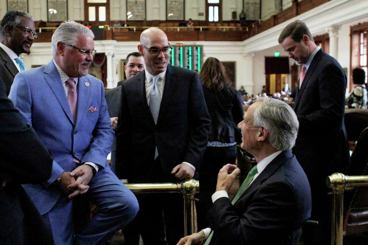 State Rep. Dan Huberty, left, R-Houston, speaks with Texas House Speaker Dennis Bonnen and Texas Gov. Greg Abbott, right, before the chamber debates a bipartisan school finance bill that would pour $9 billion into the state's public education system Wednesday, April 3, 2019, in Austin, Texas. (AP Photo/Clarice Silber)