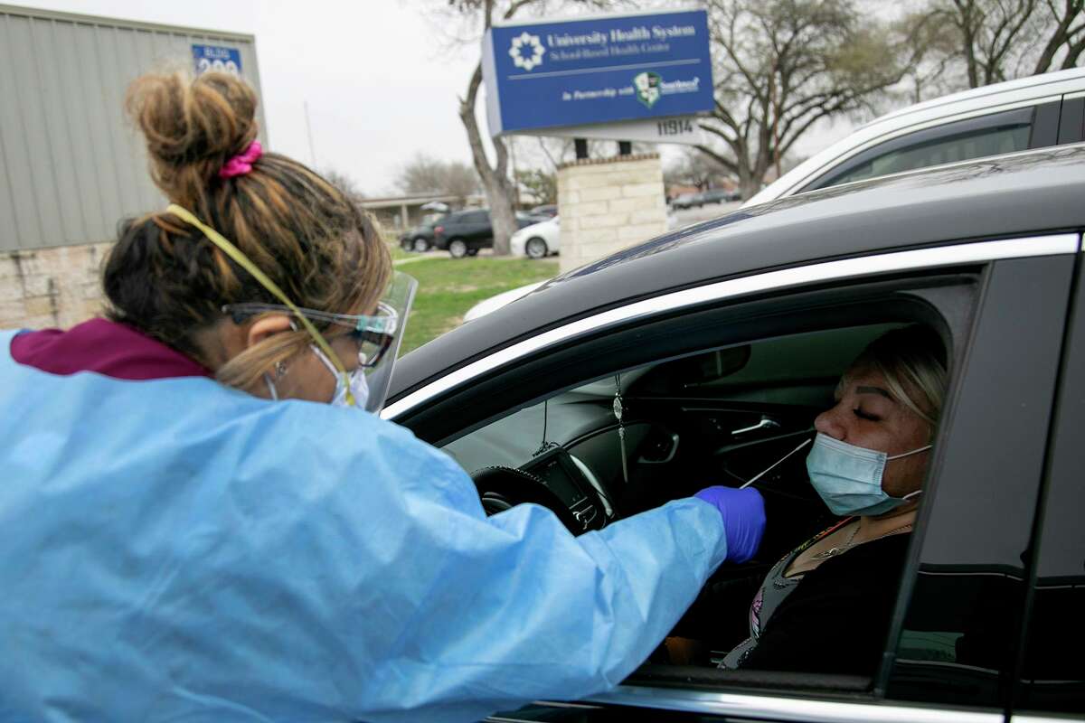 Medical Assistant Crystal Casias administers a COVID-19 nasal swab test for Irma Williams outside University Health’s Southwest ISD school-based clinic in San Antonio on Wednesday, Feb. 10, 2021.