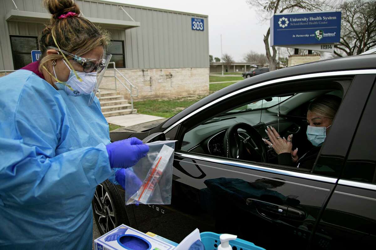 Medical Assistant Crystal Casias opens a COVID-19 nasal swab test for Irma Williams outside University Health’s Southwest ISD school-based clinic in San Antonio on Wednesday, Feb. 10, 2021.