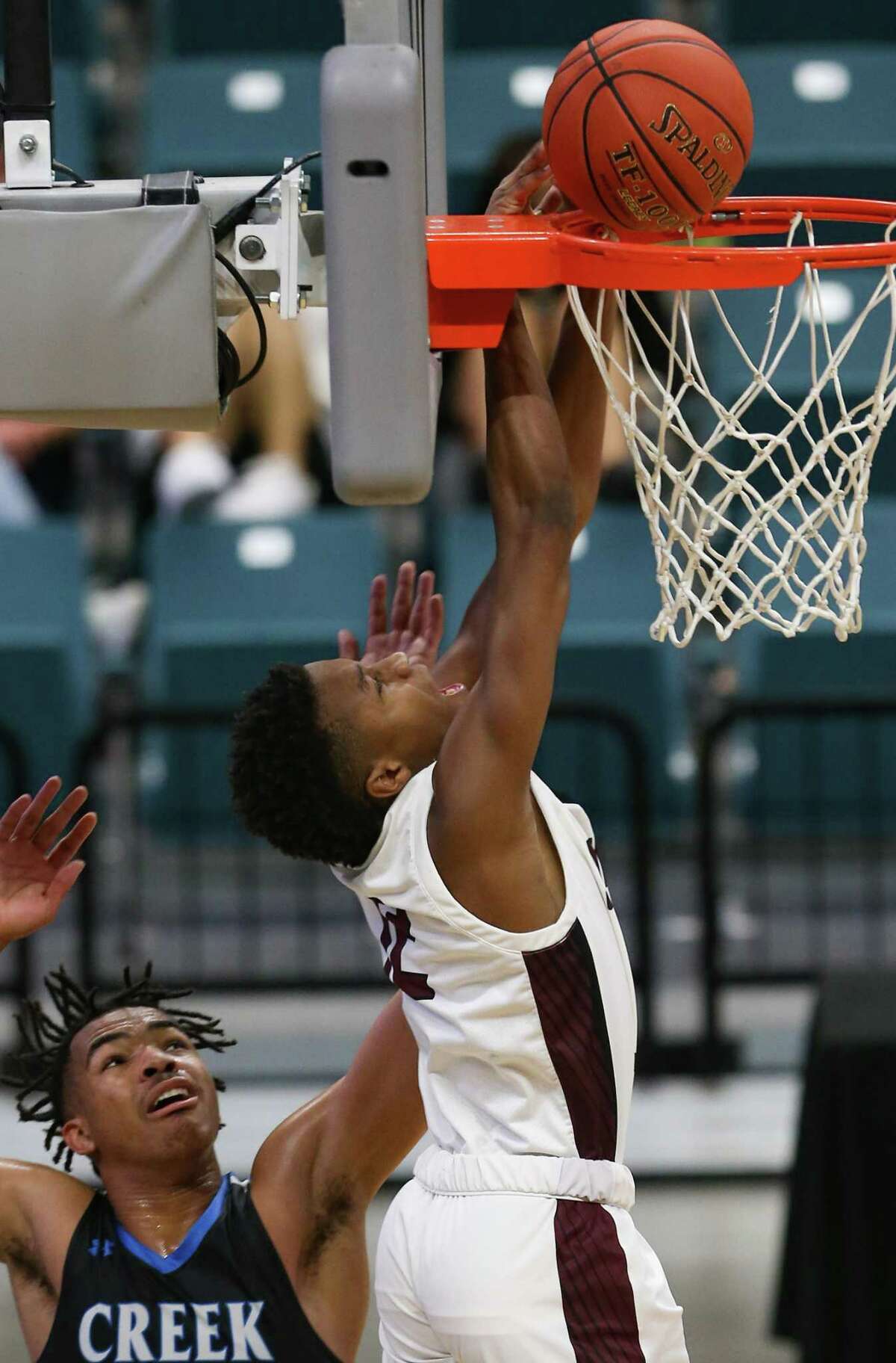 Summer Creek's Cameron Patterson (12) dunks the ball over Shadow Creek's Ramon Walker (3) during regional quarterfinals playoff game at Merrell Center in Katy on Saturday, Feb. 27, 2021. Summer Creek won the game.