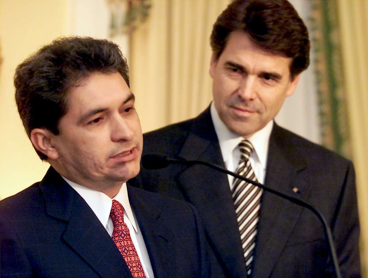 Tomas Yarrington, then governor of the Mexican state of Tamaulipas, left, talks to the media after meeting with Texas Gov. Rick Perry, right, at a news conference at the Governor's Mansion in Austin on Feb. 22, 2001. Yarrington pleaded guilty in Houston to one count of money laundering Thursday, ending a years-long case that including his extradition from Italy.