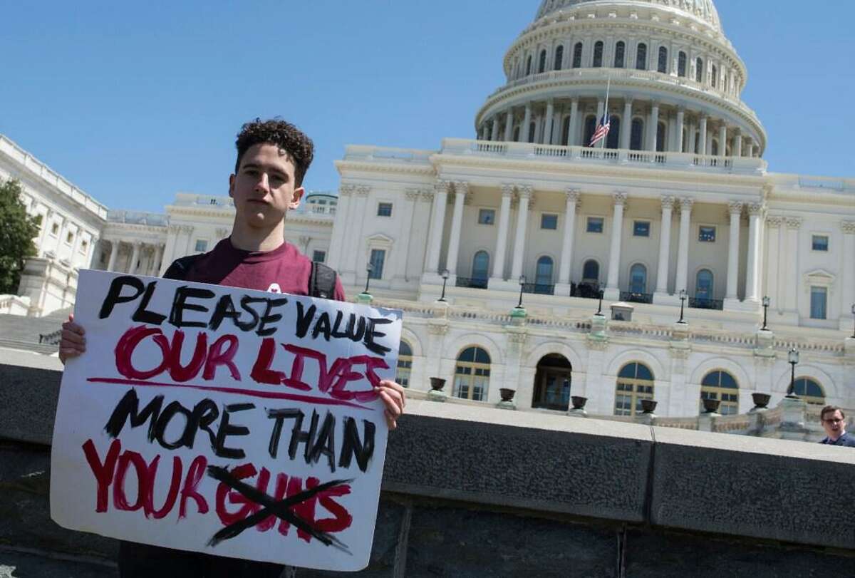 In this file photo Amit Dadon, a graduate in 2017 from Marjory Stoneman Douglas High School, poses for a photo on the West Lawn of the US Capitol after rallying with several hundred fellow students to call for stricter gun laws in Washington, DC on April 20, 2018 to protest gun violence.