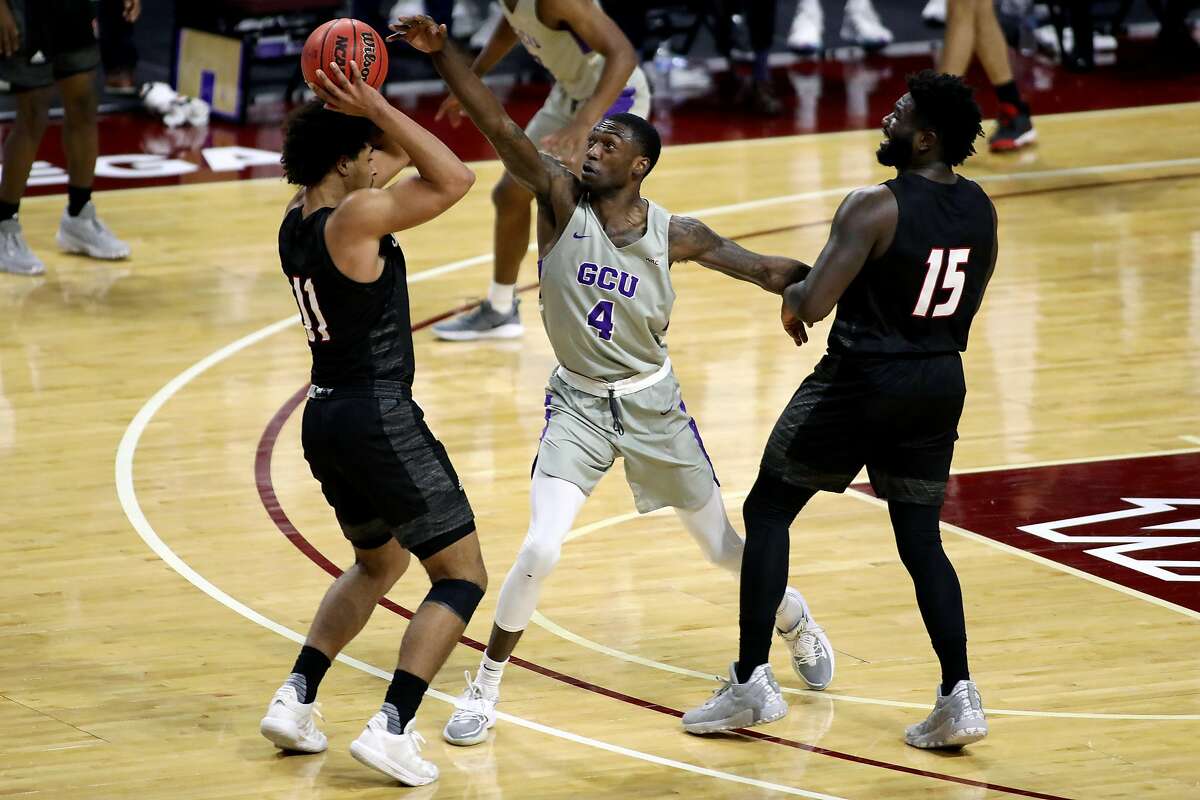 Grand Canyon University player Oscar Frayer (center), shown playing aggressive defense March 12 against Seattle University, died Tuesday after a car crash near Lodi.
