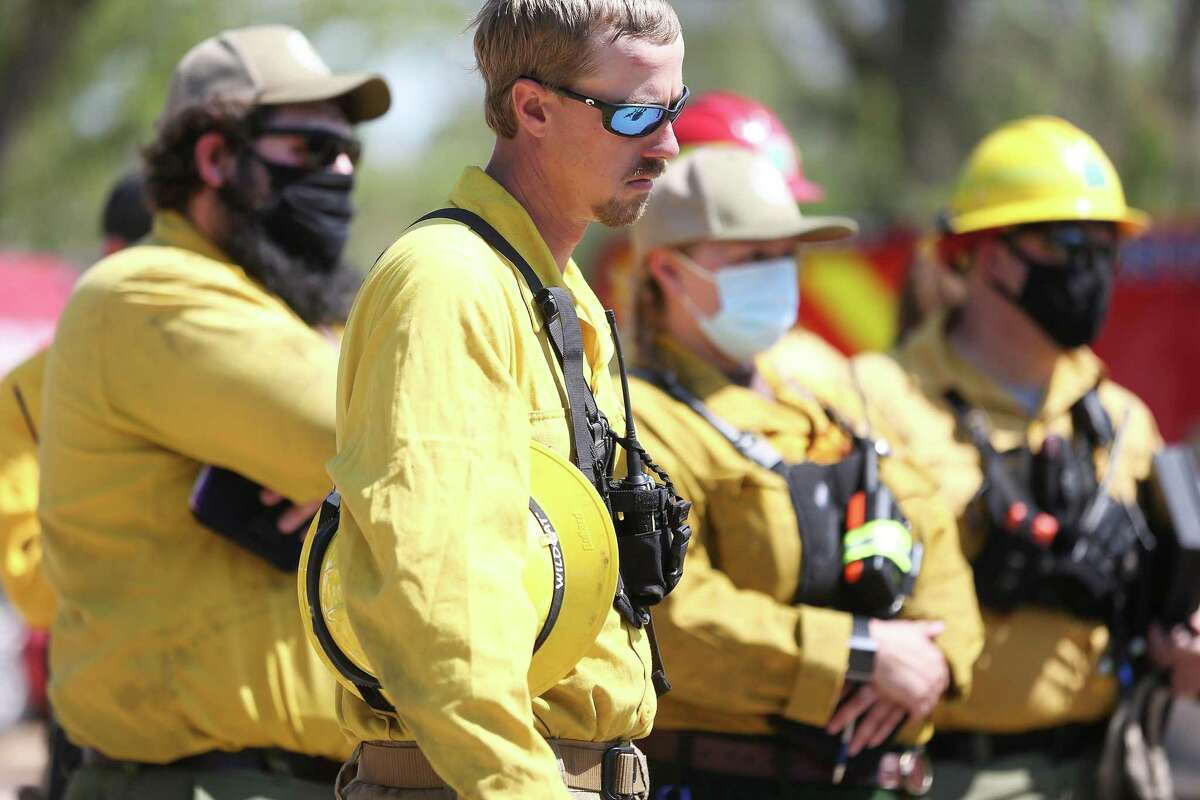 Members of the Texas Parks & Wildlife Department wait for instructions on a prescribed fire at the Houston Arboretum & Nature Center on Thursday, March 25, 2021.