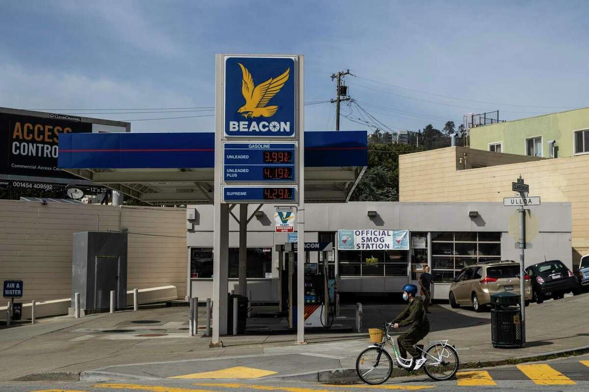A bicyclist rides past a Beacon gas station in San Francisco in March. Mayor London Breed has proposed an ordinance that would make it easier for car-centric properties, like gas stations, to be converted into housing.