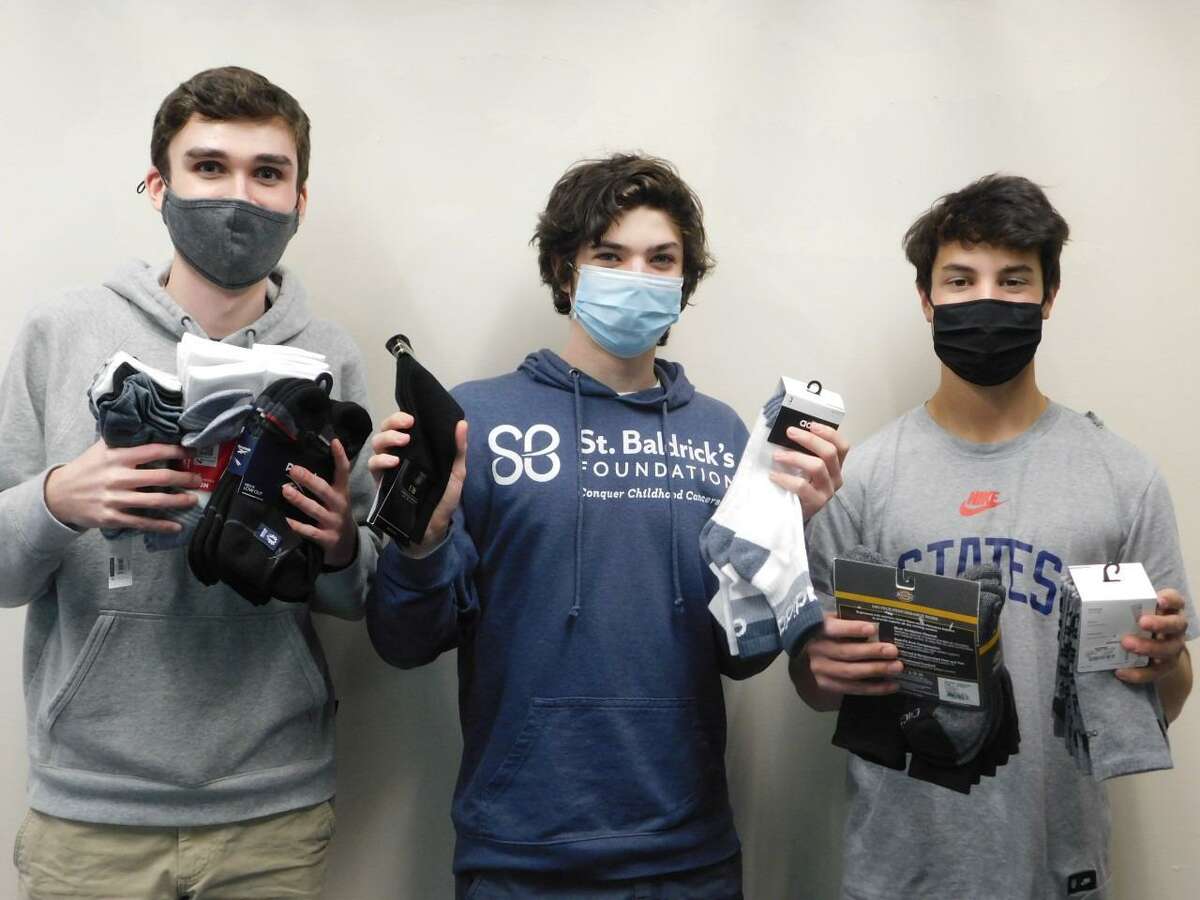 The Socks for Soldiers Organization at Wilton High School has begun its last drive for the 2021 school year. The drive began on March 22 and will run through April 14. Roen Crameri, left, Eli Ackerman and Tyler Casey are program coordinators for the organization, Sock for Soldiers, at the high school.