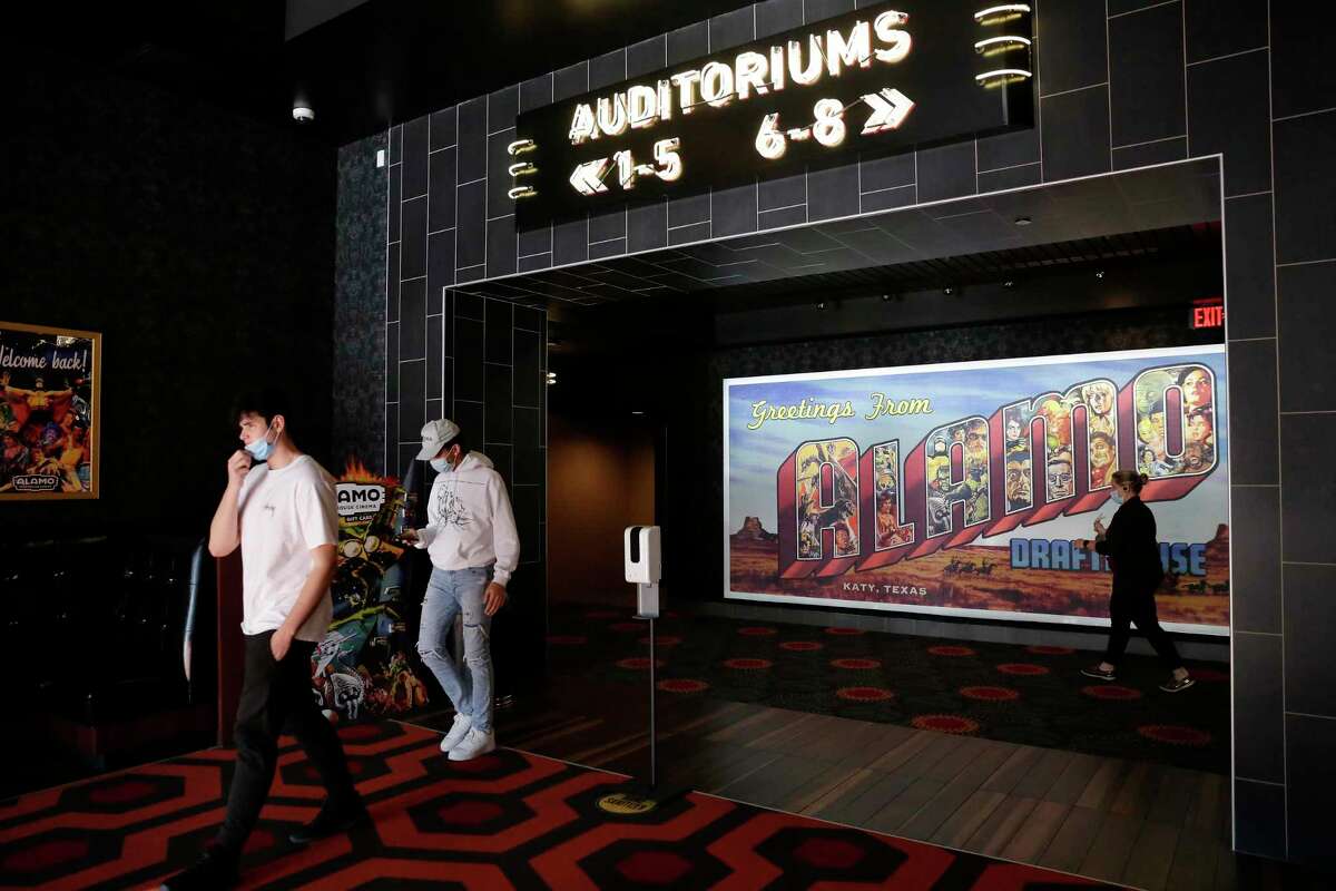 Customers leave after watching a movie at the Alamo Draft House Cinema Thursday, Mar. 18, 2021 in Katy, TX.