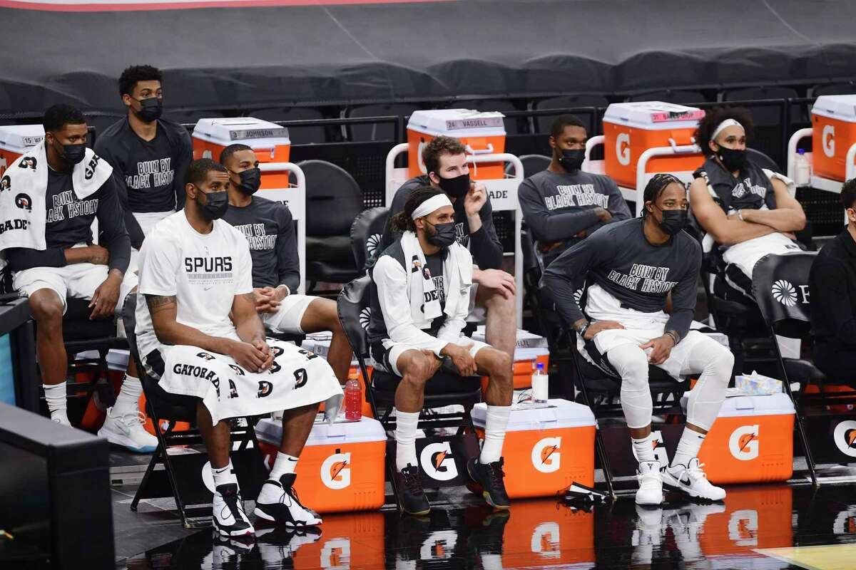 In front row, LaMarcus Aldridge, left, Patty Mills and DeMar DeRozan watch as the clock winds down on the San Antoni Spurs' 133-102 loss to the Memphis Grizzlies in the AT&T Center on Monday, Feb. 1. 2021.