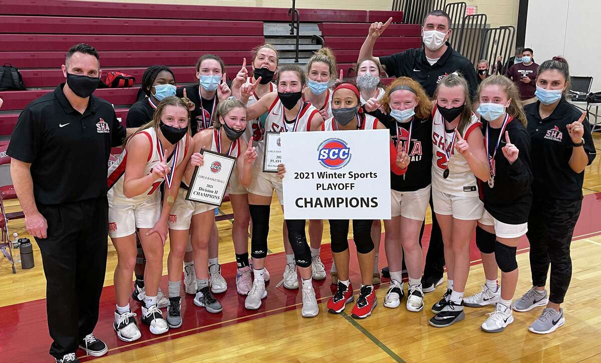 Members of the Sacred Heart Academy girls basketball celebrate after beating West Haven to win the SCC Division II championship on Thursday.