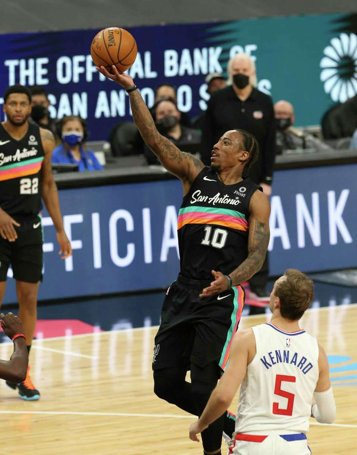 Spurs' DeMar DeRozan (10) scores the last shot of the first half against the Los Angeles Clippers' Luke Kennard (05) at the AT&T Center on Thursday, Mar. 25, 2021.