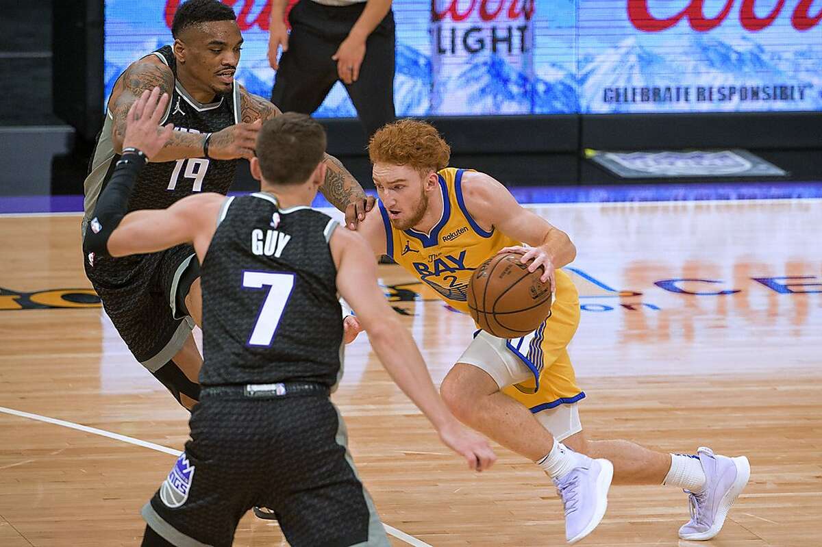 Sacramento Kings guard DaQuan Jeffries (19) guard Kyle Guy (7) defend against Golden State Warriors guard Nico Mannion (2) during the first quarter of an NBA basketball game in Sacramento, Calif., Thursday, March 25, 2021. (AP Photo/Randall Benton)