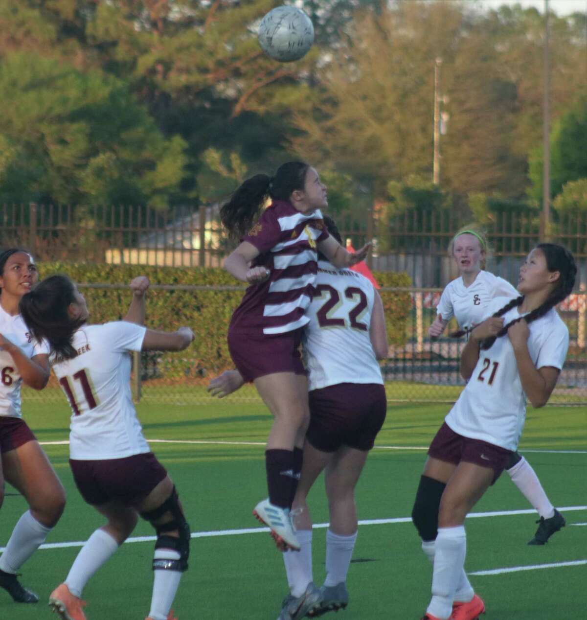 Outnumbered 5-1, a Deer Park player leaps up to head the ball not far from the Summer Creek goal Thursday night.