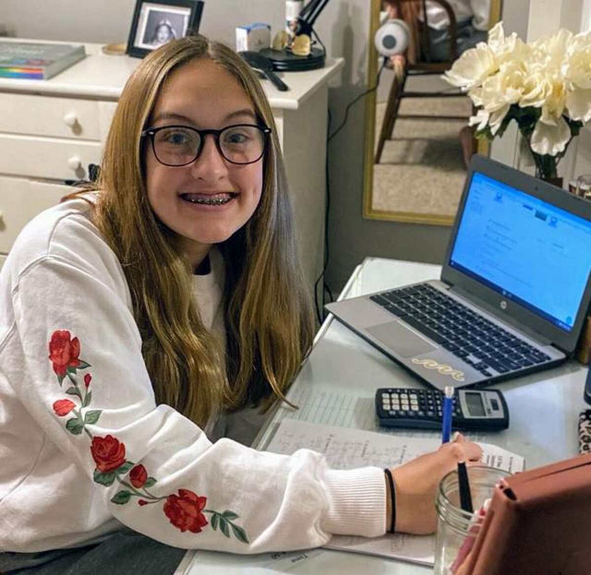 Liberty Middle School student Alayna Garman completes her classwork at home.