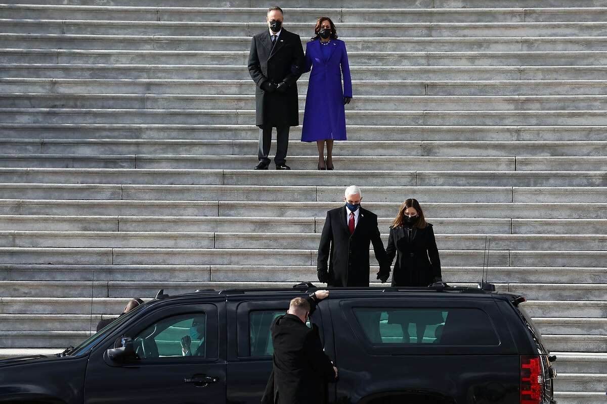 Second gentleman Doug Emhoff and Vice President Kamala Harris watch former Vice President Mike Pence and his wife, Karen, depart on Inauguration Day.