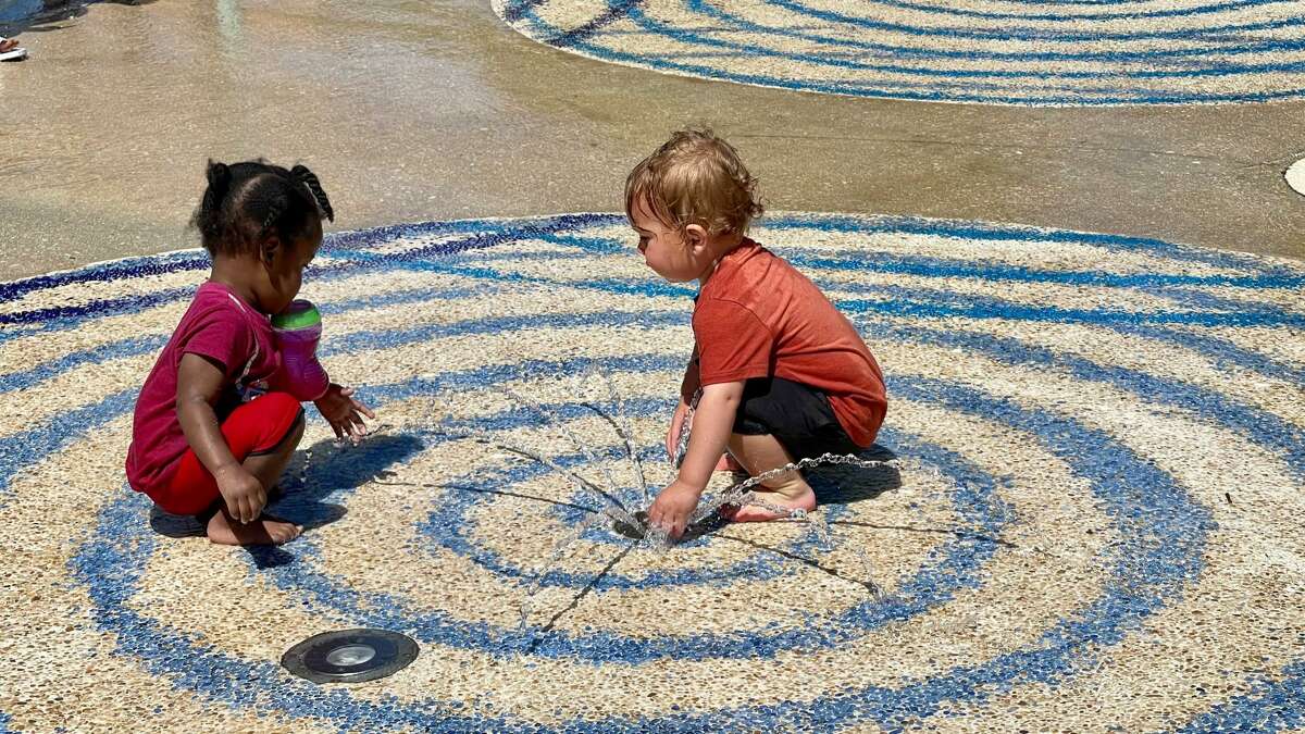 Children cooling off from the hot weather in a splash pad in San Antonio. 
