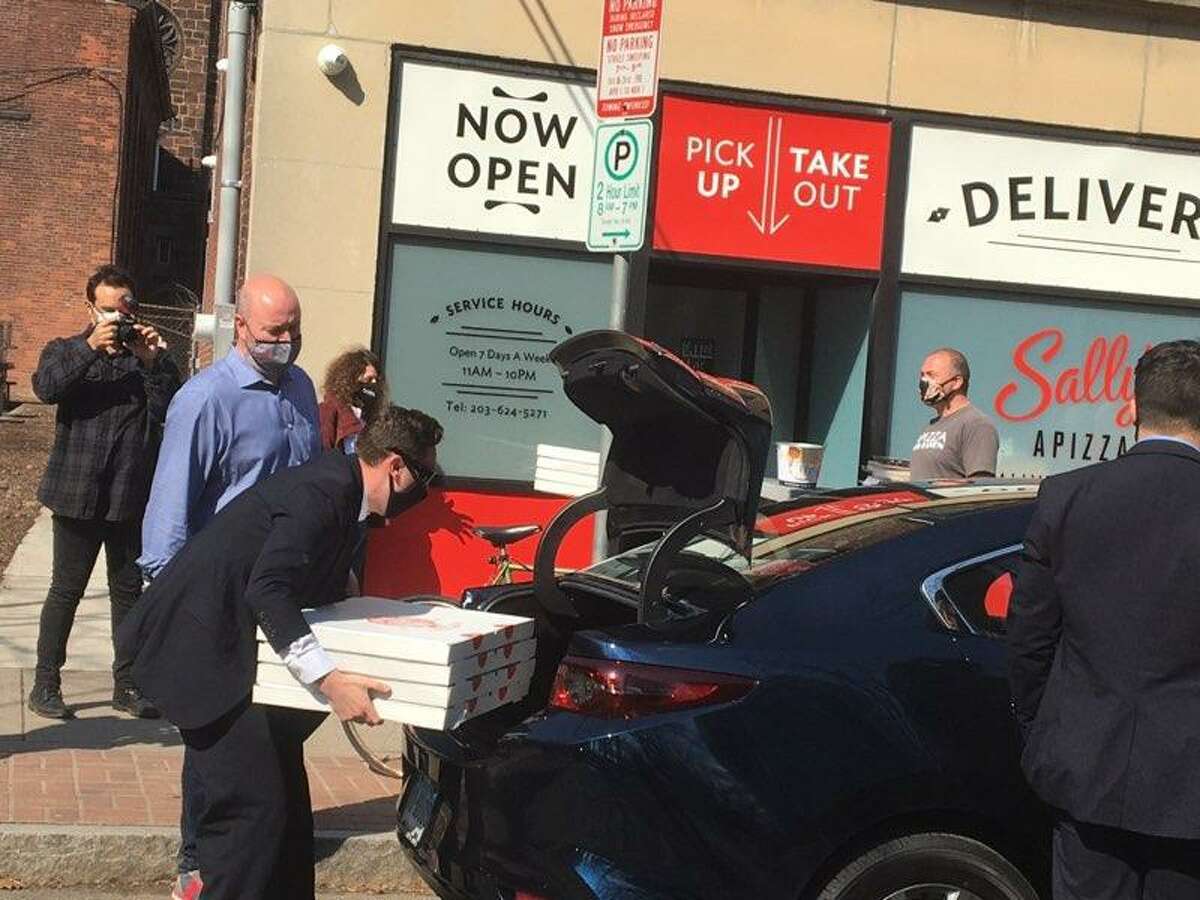 Pizzas are picked up from Sally’s Apizza in New Haven Friday for Vice President Kamala Harris and her entourage.