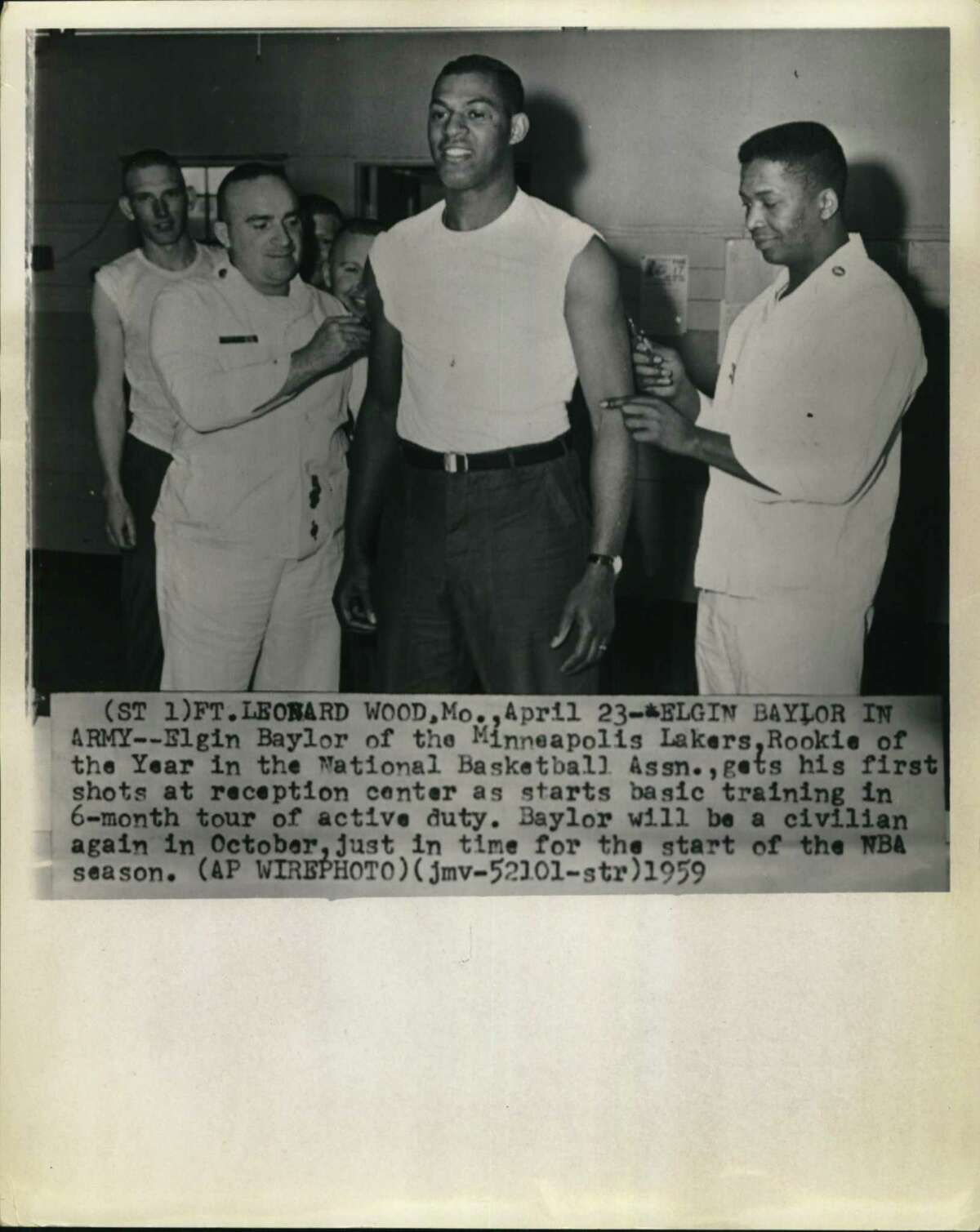 Elgin Baylor of the then-Minneapolis Lakers, the National Basketball Association’s Rookie of the Year, gets his first vaccinations April 23, 1959, at Fort Leonard Wood, Mo. In July and August, he was in San Antonio at Fort Sam Houston to train as a medical corpsman during a 6-month tour of active duty. He became a civilian again in October, just in time for the start of the NBA season.