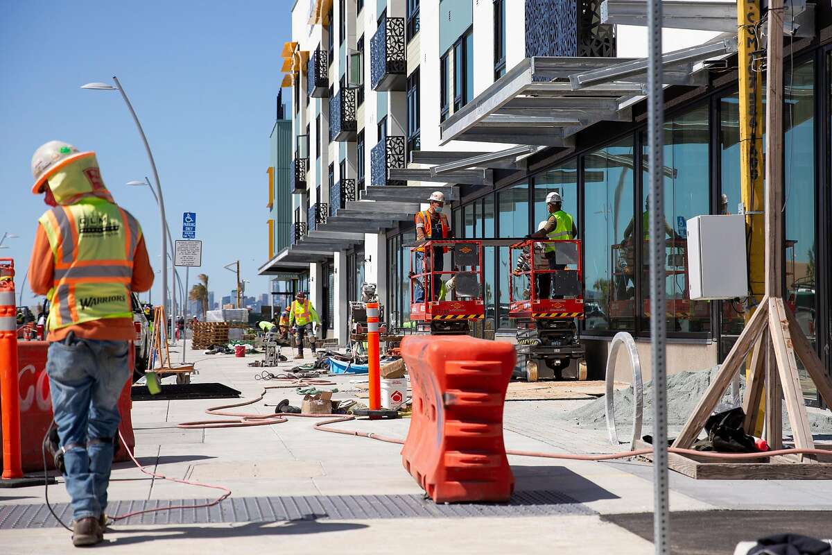Construction crews work on the AERO Apartments building at Alameda Point in Alameda, Calif. on Tuesday, March 23, 2021
